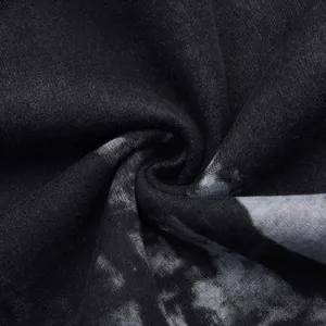 Macro detail of black fabric with grey ink splatter pattern and soft texture