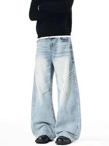 Men's loose fit light blue distressed curved leg jeans with pleated scratch details