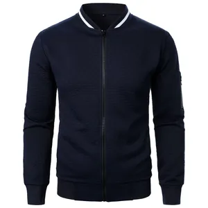 Close-up of navy blue men's jacquard zip-up bomber jacket with textured pattern