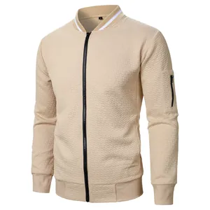Detailed macro shot of men's beige jacquard bomber jacket with sleeve zipper pocket