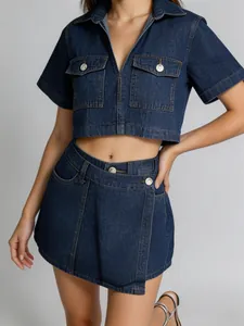 Detail view of denim two-piece set featuring V-neck cropped top and irregular hem skirt