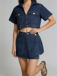Two-piece denim set featuring a cropped short-sleeve top and asymmetrical skort.