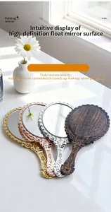 Vintage style handheld makeup mirrors with ornate embossed frames in various metallic finishes