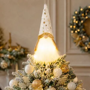 Detailed close-up of a white plush gnome Christmas tree topper with warm LED lighting