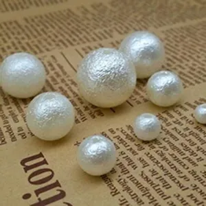 Macro detail of white wrinkled matte ABS imitation pearl beads for DIY jewelry making