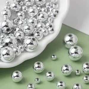 Close-up of shiny silver ABS wrinkled imitation pearl beads with straight holes for DIY jewelry