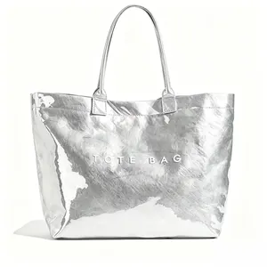 Minimalist silver metallic tote bag with embossed TOTE BAG text and crinkled texture