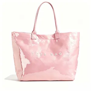 Detailed view of a pink metallic finish tote bag with white TOTE BAG text on front side