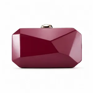 Close-up of elegant wine red geometric faceted evening clutch with gold clasp
