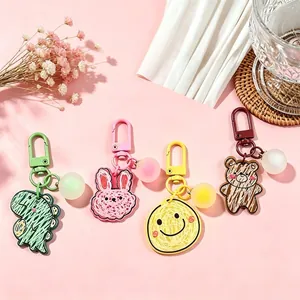 Cute cartoon acrylic keychains featuring dinosaur bunny bear and smiley face charms