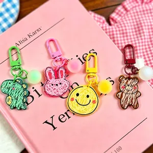 Cute acrylic cartoon animal keychains featuring dinosaur rabbit bear and smiley face charms