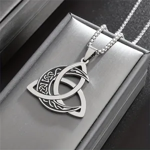 Macro detail of a silver stainless steel Viking triquetra knot and crescent moon pendant