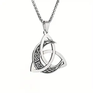 Close-up of a vintage stainless steel Viking Celtic knot and moon pendant necklace.