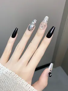 Macro view of luxury black and silver press-on nails with cat-themed 3D decorations