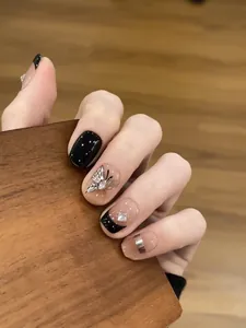 Elegant black French press-on nails with silver butterfly and rhinestone decorations