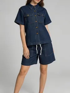 Detailed view of retro dark blue denim two-piece set featuring lapel shirt and shorts