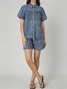 Full-body studio shot of women's vintage loose denim shirt and shorts set in blue