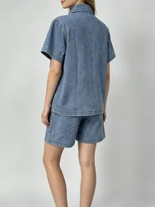 Back view of women's vintage loose denim short-sleeved shirt and casual shorts set
