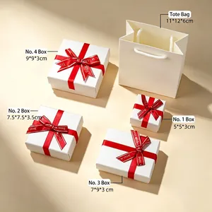White jewelry gift box set with red ribbon bows and matching tote bag in various sizes