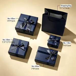 Elegant navy blue jewelry gift packaging set with ribbon bows and matching tote bag