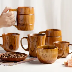 Handcrafted assorted solid wood coffee cups and whiskey mugs with natural wood grain