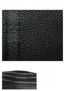 Detalle macro de la textura de cuero granulado de calidad y cremalleras metálicas duraderas