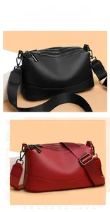 Detalle de bolso bandolera de cuero auténtico con cremalleras y correa ancha.