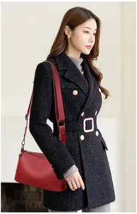 Professional shot of a stylish red genuine leather crossbody bag worn by an Asian model