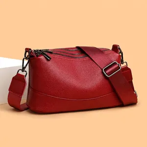 Elegant red genuine leather crossbody bag with multiple zippers and adjustable wide strap