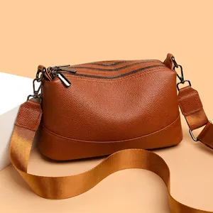 Premium brown genuine leather crossbody bag for women featuring three zipper compartments