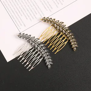 Close-up of gold and silver leaf-shaped hair combs with rhinestone details.
