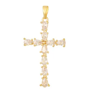 Elegant gold-plated cross pendant featuring pear-cut cubic zirconia stones on white background.