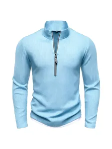 Close-up view of a light blue ribbed knit sweater with a stylish half-zip stand collar