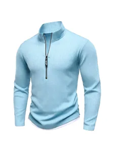 Detailed view of a light blue ribbed knit sweater with a half-zip stand collar