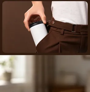 Portable white stainless steel coffee thermos cup shown fitting into a side trouser pocket