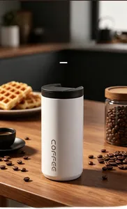 Modern white stainless steel coffee thermos cup on a wooden table with coffee beans.
