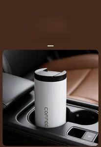 Portable white stainless steel insulated coffee cup placed in a car cup holder