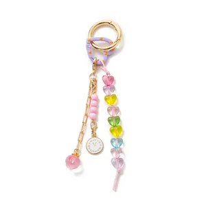 Detailed view of colorful heart-shaped beads and clock charm on a vintage bag accessory