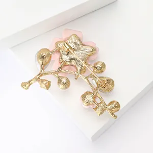 Reverse side detail of elegant alloy cherry blossom brooch with gold-plated finish and pin