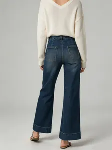 Back view of women's high-waist wide-leg washed denim jeans with cuffed hem design