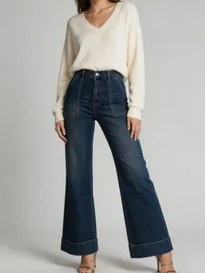 High-waisted wide-leg denim jeans for women featuring washed finish and cuffed hem.