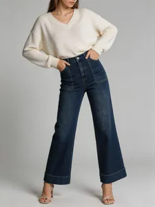 Detailed view of high-waisted wide-leg washed denim jeans for women with cuffs