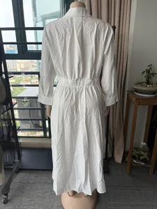 Vue arrière d'une robe chemise blanche à manches longues avec taille élastique.