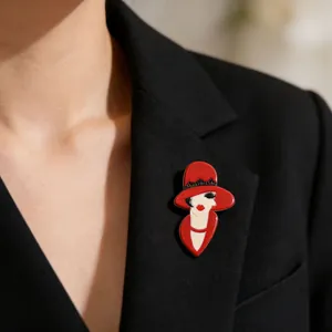 Chic acrylic lady brooch featuring a red hat design styled on a black blazer lapel