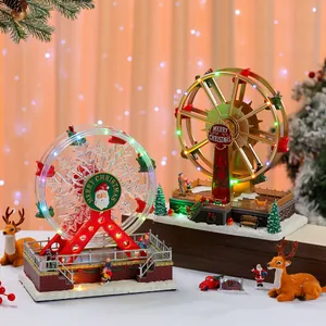 Detailed view of two illuminated Christmas ferris wheel music boxes with festive decorations.
