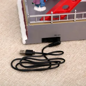 Close-up of USB power cable and 4.5V DC port on Christmas ferris wheel music box