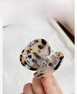 Detailed view of high-end tortoiseshell acetate hair claw clip with elegant texture