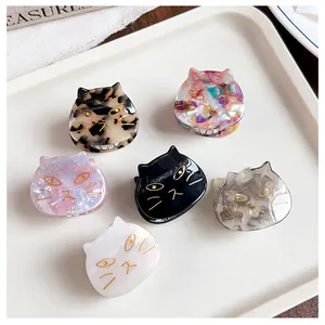 Detailed close-up view of multiple cat-shaped acetate hair claw clips in various colors