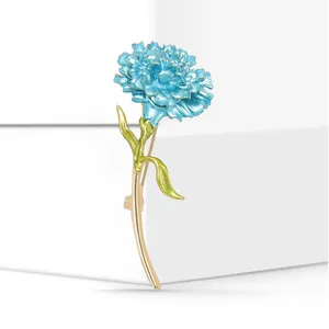 Elegant blue enamel carnation brooch detail with gold-plated stem and green leaves.