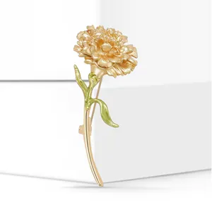 Exquisite gold-plated carnation brooch with green enamel stem and leaves detail